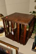 A MINIATURE OAK REVOLVING BOOKCASE, fitted on a metal base (consisting of a copper lid and three