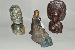 A RESIN FIGURE OF A SEATED AFRICAN LADY, a carved treen bust of an Asian lady and a carved stone