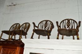 FOUR OAK WHEEL BACK CHAIRS including two carver chairs