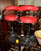 A PAIR OF CHROME FRAMED SWIVEL BAR STOOLS with red leatherette seat and back