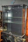 A MODERN GLAZED TWO DOOR DISPLAY CABINET