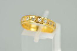 A 22CT GOLD DIAMOND HALF ETERNITY RING, the plain band set with nine single cut diamonds,