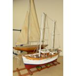 A WOODEN SCRATCH BUILT MODEL OF A FISHING VESSEL painted red and white on a wooden stand,