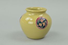 A SMALL MOORCROFT POTTERY FLAMMINIAN WARE VASE, decorated with roundels on a beige ground, impressed