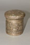 A LATE 19TH/EARLY 20TH CENTURY INDIAN WHITE METAL CYLINDRICAL BOX AND COVER, embossed with buildings