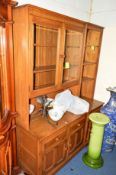 AN ERCOL ASH TWO SECTION WALL UNIT, comprising of a double glazed cupboard, an open section above