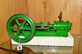 A HORIZONTAL SINGLE CYLINDER LIVE STEAM ENGINE, not tested, mounted on a re-painted brick effect