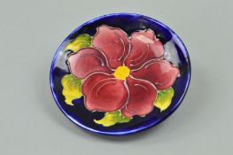A MOORCROFT POTTERY TRINKET DISH, 'Clematis' pattern on blue ground, impressed marks to base,
