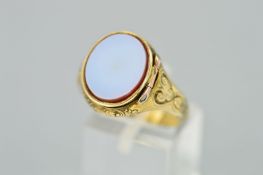 A MID VICTORIAN GOLD POISON/LOCKET RING, designed as an oval chalcedony hinged panel opening to a