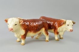 A HEREFORD BULL AND COW, marked to base Made in England, (possibly Coopercraft) (2)