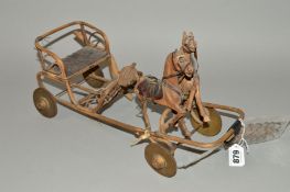 A VINTAGE WOODEN GALLOPING GIG PULL-ALONG TOY, of cane construction with metal wheels, two carved