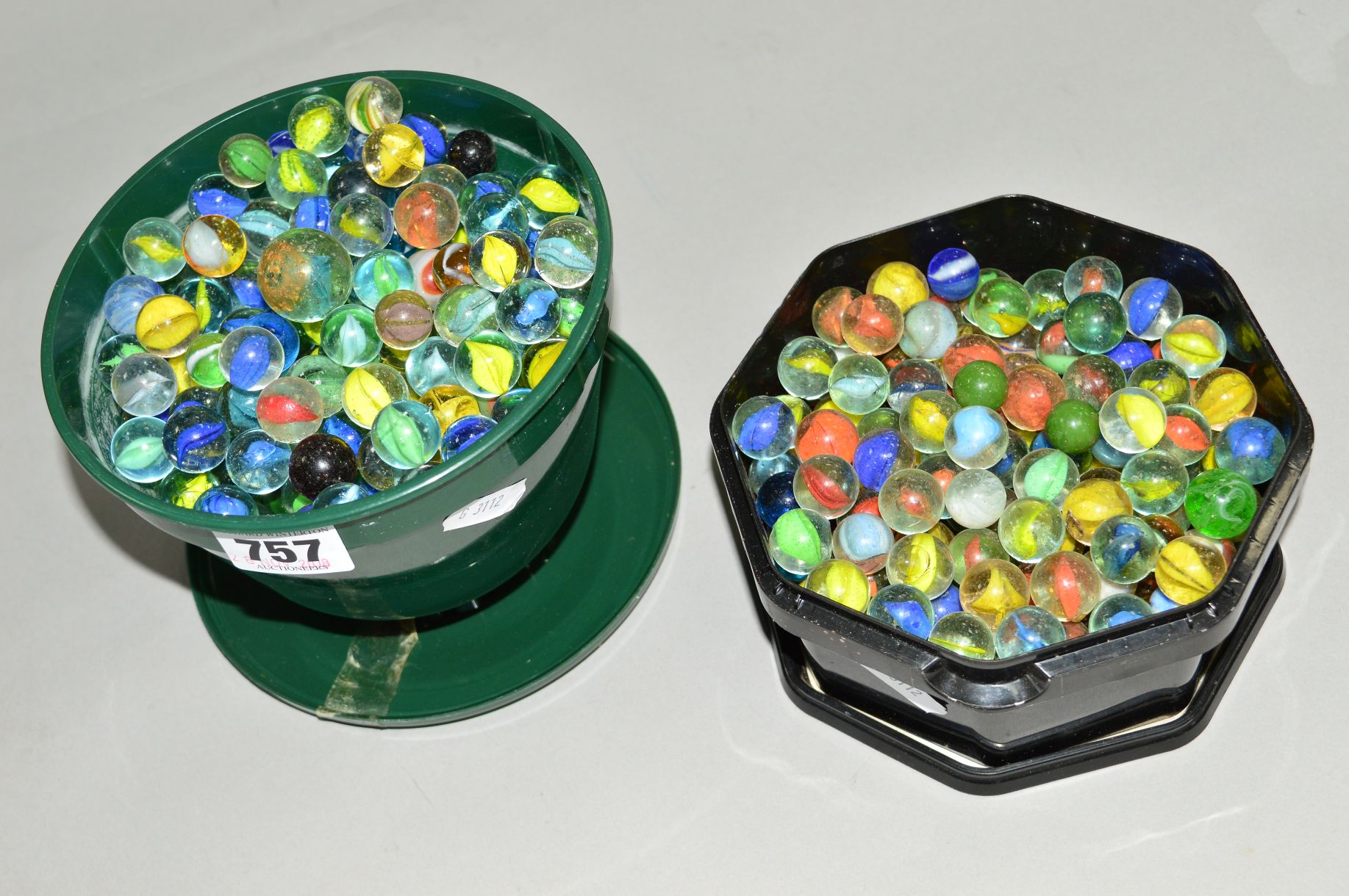 TWO PLASTIC TUBS OF GLASS MARBLES