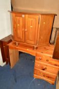A MODERN PINE CORNER TV STAND/CUPBOARD, together with a pine desk with three drawers and a teak drop