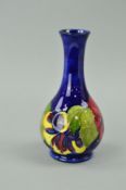 A MOORCROFT POTTERY BUD VASE, 'Hibiscus' pattern on blue ground, paper label to base, approximate