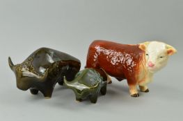 A MELBA WARE HEREFORD BULL, approximate length 26cm and two studio 'Lotus' pottery bulls,