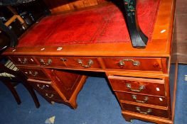 A MODERN YEW WOOD PEDESTAL DESK with a red tooled leather inlay top and eight various drawers,