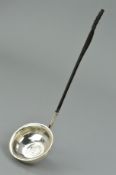 A LATE GEORGIAN SILVER LADLE, the bowl centrally set with an 1818 George III coin with a twisted