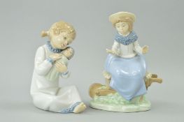 TWO NAO FIGURES, girl sitting on wheelbarrow (missing bird off hand) and young girl with dog (2)