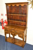 A TITCHMARSH AND GOODWIN OAK DRESSER with a two tier plate rack above five various drawers, on