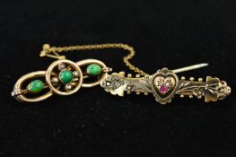 TWO EARLY 20TH CENTURY GOLD BROOCHES, the first designed as a central heart set with two diamonds