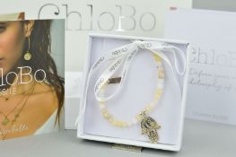 A CHOLOBO BRACELET WITH A HAMSA HAND CHARM