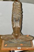 A BRONZED FIGURE OF A SEATED FEMALE NUDE, mounted on a rectangular oak base, approximate height