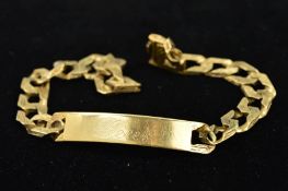 A 9CT GOLD IDENTITY BRACELET, the plain curved panel with personal engraving to the textured curb