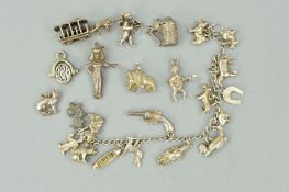 A CHARM BRACELET AND LOOSE CHARMS, the charm bracelet suspending fifteen charms to include animal