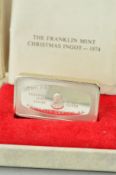 A CASED FRANKLIN MINT SILVER BAR of rectangular outline with an outdoor snowy scene to the