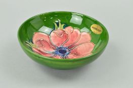 A MOORCROFT POTTERY FOOTED BOWL, 'Anemone' pattern on green ground, impressed marks to base and