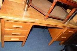 AN OAK DESK with six various drawers