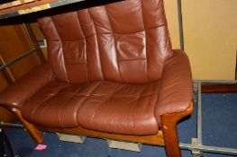 AN EKORNES TWO SEATER BROWN LEATHER SOFA