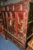 A 20TH CENTURY ORIENTAL STAINED WOOD TWO DOOR CABINET, the various panels with detailed scenes and