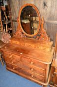 A VICTORIAN WALNUT DUTCHESS DRESSING TABLE with an oval mirror above seven various drawers,