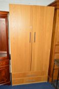 A MODERN LIGHT OAK TWO DOOR WARDROBE above two drawers, approximate size width 100cm x depth 60cm