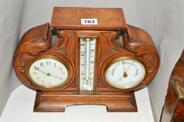 A LATE 19TH/EARLY 20TH CENTURY CLOCK, thermometer barometer set in a carved oak frame with splayed