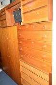 AN AUSTIN SUITE TEAK CHEST OF FOUR LONG GRADUATED DRAWERS with rosewood finish handles, on four