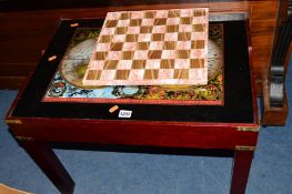 A MAHOGANY GAMES COFFEE TABLE with internal games pieces