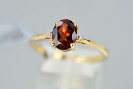 A MODERN 9CT GOLD GARNET AND DIAMOND THREE STONE RING, ring size T 1/2, hallmarked 9ct gold,