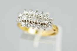 AN 18CT GOLD DIAMOND DRESS RING, designed as a raised row of five princess cut diamonds within a