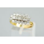 AN 18CT GOLD DIAMOND DRESS RING, designed as a raised row of five princess cut diamonds within a