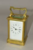 AN EARLY 20TH CENTURY BRASS CASED CARRIAGE CLOCK, five bevel edged glass panels, white enamel dial