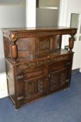 A 17TH CENTURY CARVED OAK COURT CUPBOARD, the upper section with a single panelled door, flanked