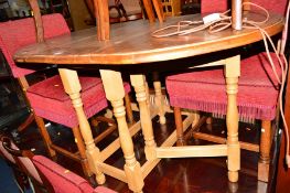 A PINE DROP LEAF TABLE together with four oak upholstered chairs (5)