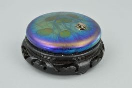 JOHN DITCHFORD FOR GLASFORM, a circular iridescent paperweight decorated with lily pads and having a