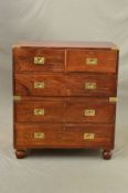 A LATE 19TH CENTURY MAHOGANY CAMPAIGN CHEST OF DRAWERS, brass mounts to upper corners, two short