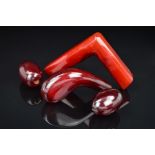 TWO RED PLASTIC WALKING STICK HANDLES AND TWO LARGE RED PLASTIC BEADS, one handle of curved shape,