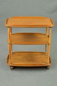 AN ERCOL ELM THREE TIER TEA TROLLEY, on orbit castors, width 72cm x depth 46cm x height 74cm (