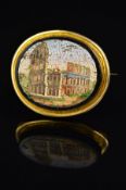 A MID 19TH CENTURY MICRO MOSAIC BROOCH, the oval plaque depicting a ruined Colosseum within onyx