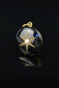 A MID VICTORIAN GOLD ENAMEL, DIAMOND AND PEARL MEMORIAL PENDANT, of circular outline, the star